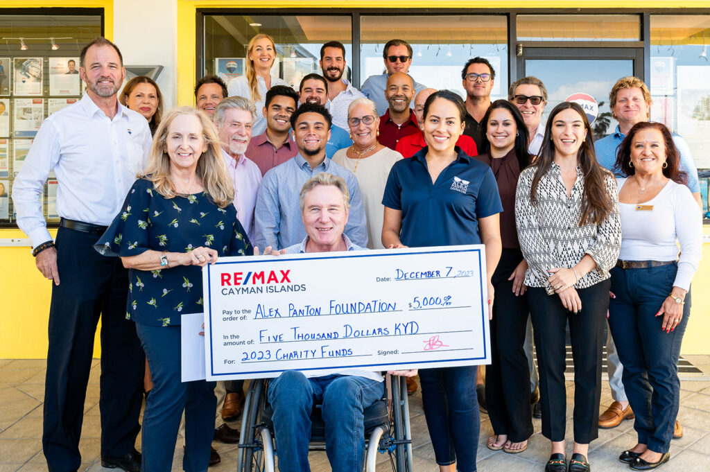 REMAX team outside office with Alex Panton donation cheque